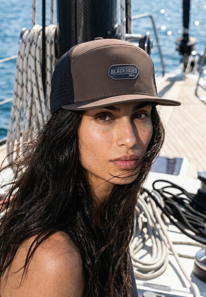 Woman wearing a cap with a brand logo on a boat deck