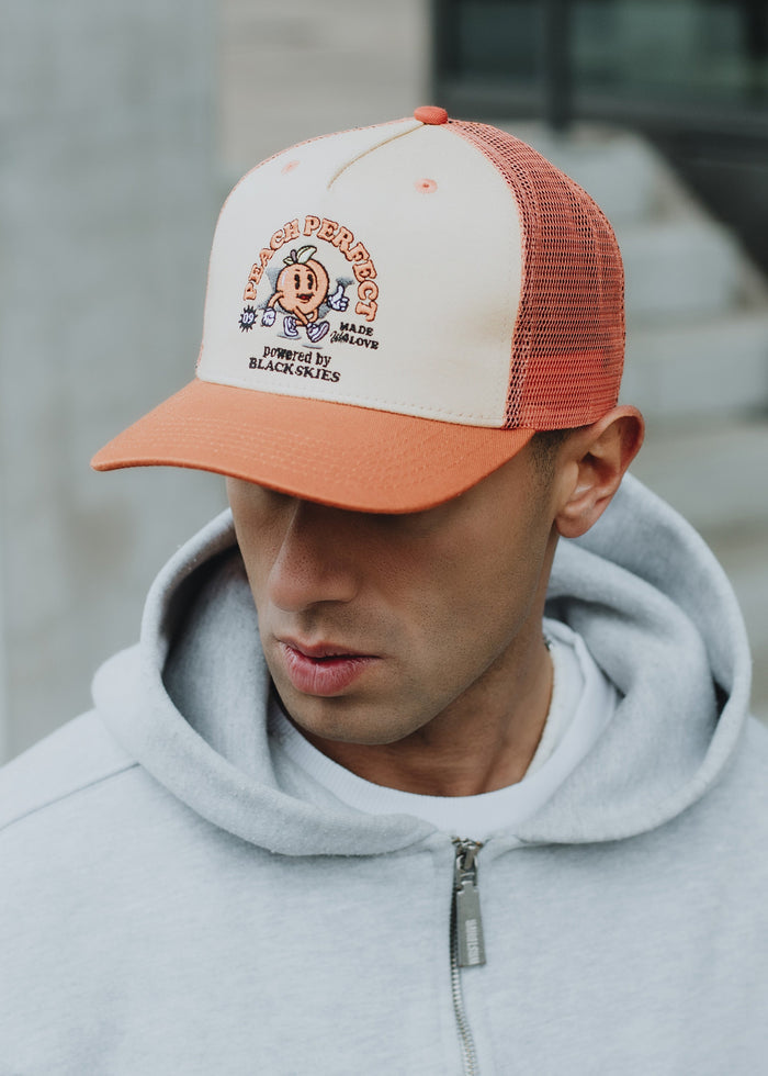 Blackskies-15th-Anniversary-Trucker-Cap-Peach-Model