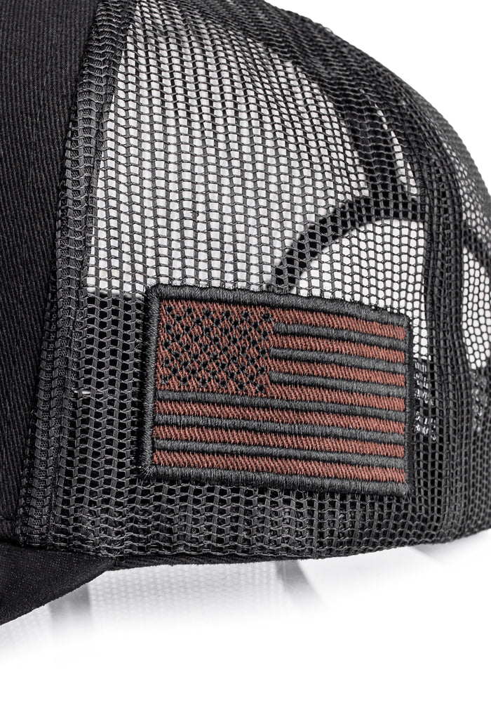 Black mesh cap with American flag patch on a white background