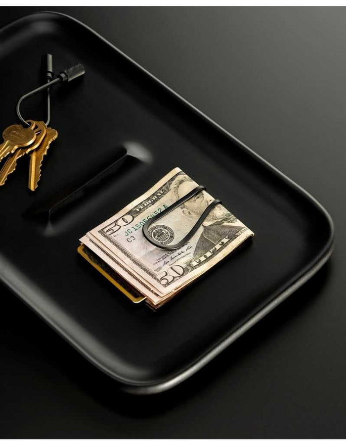 Money clip on black tray with keys