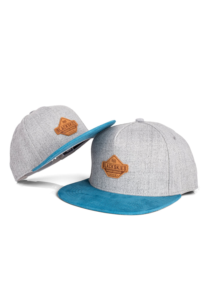 Gray and blue cap with a brown logo on a white background