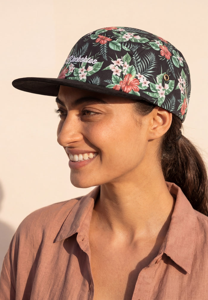 Woman wearing a floral cap with a neutral background