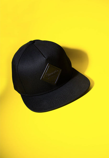 Black cap with a logo on a yellow background