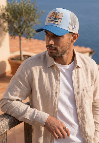 Man wearing a cap with a scenic background