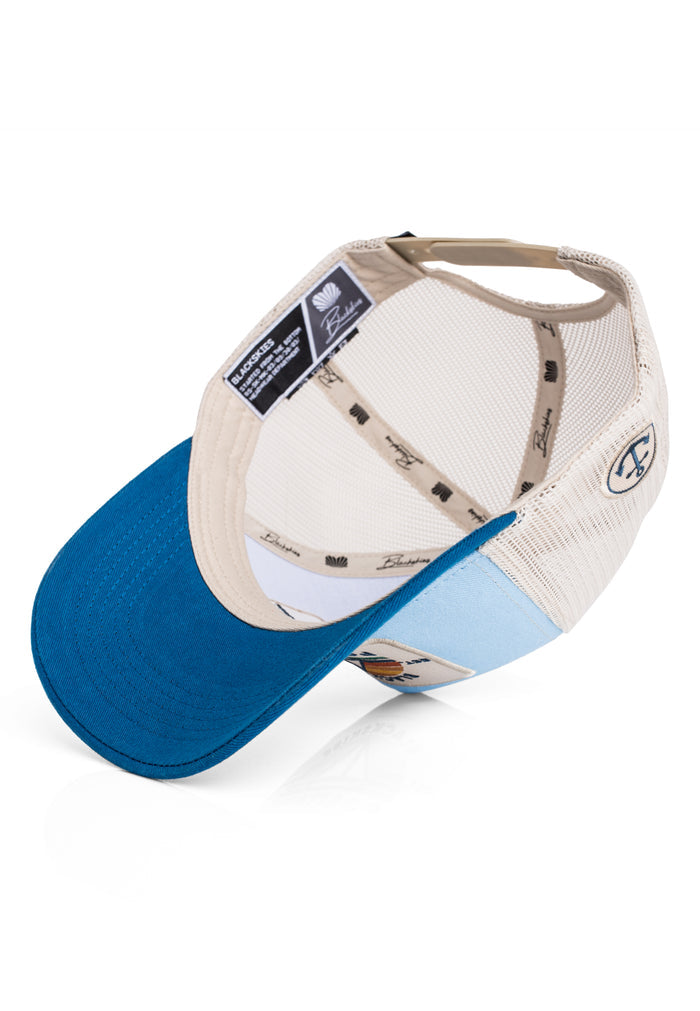 Blue and beige cap with mesh back on a white background