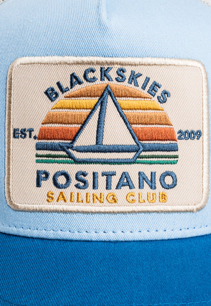Patch on a blue cap with 'Blackskies Positano Sailing Club' design