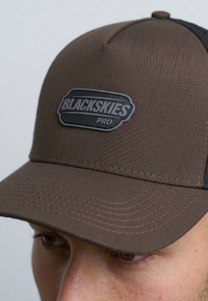 Brown cap with Blackskies Pro logo on a gray background