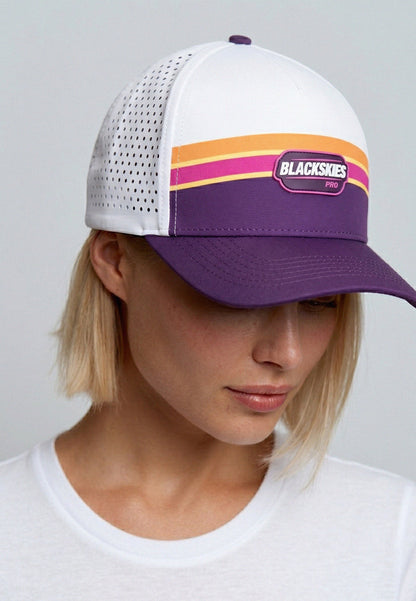 Person wearing a white and purple cap with colorful stripes and 'Blackskies' branding.