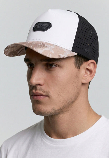 Man wearing a cap with a camouflage pattern on a plain background