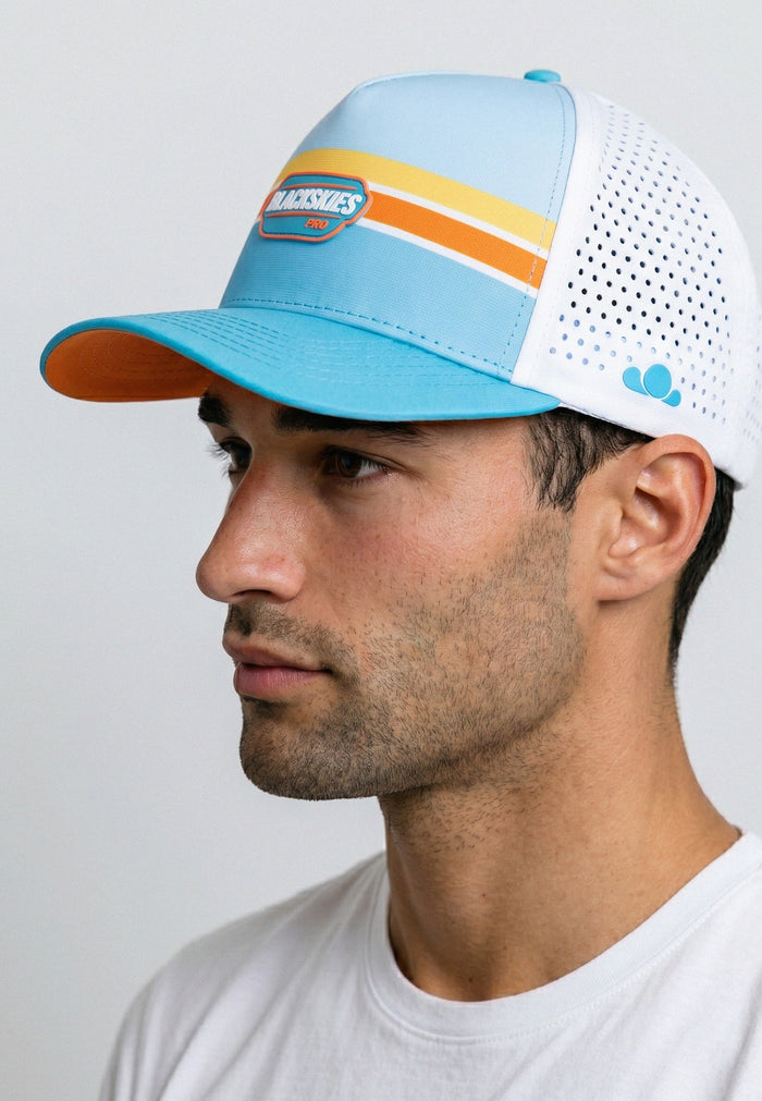 Man wearing a colorful baseball cap with a white background