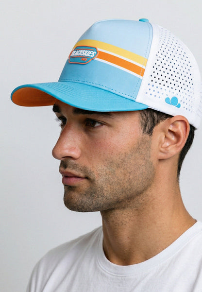 Man wearing a colorful baseball cap with a white background