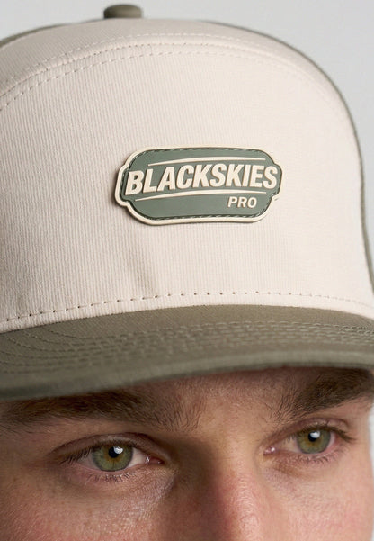 Beige cap with Blackskies Pro logo worn by a person