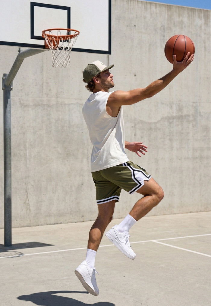 Man playing basketball on an outdoor court