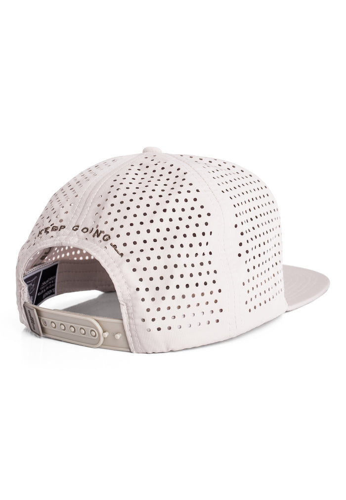 White cap with perforated design on a white background
