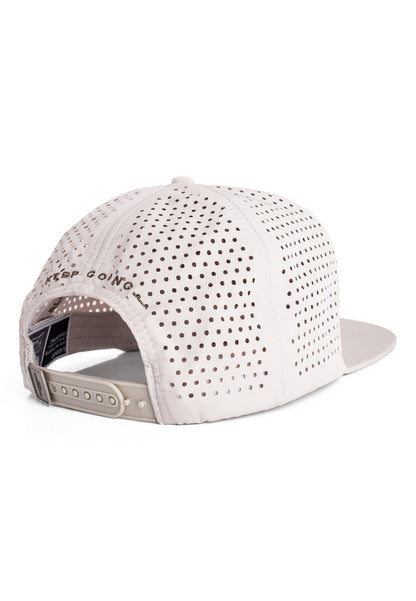 White cap with perforated design on a white background