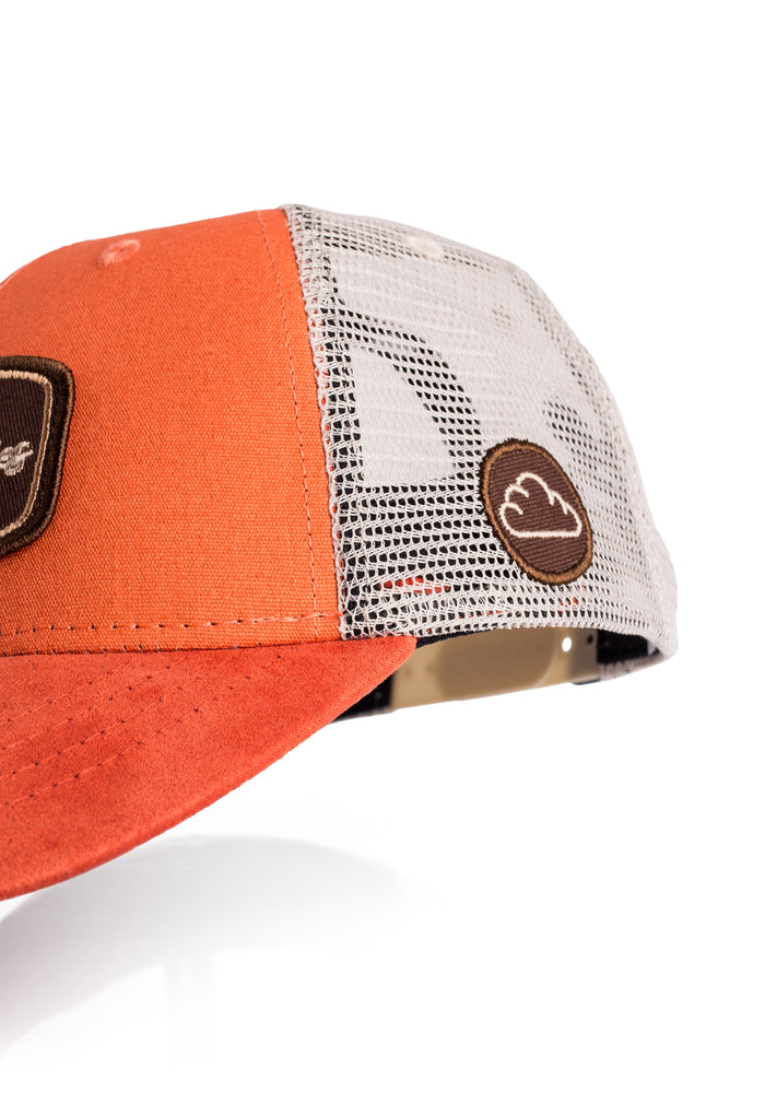 Orange cap with a mesh back and brown patch on a white background