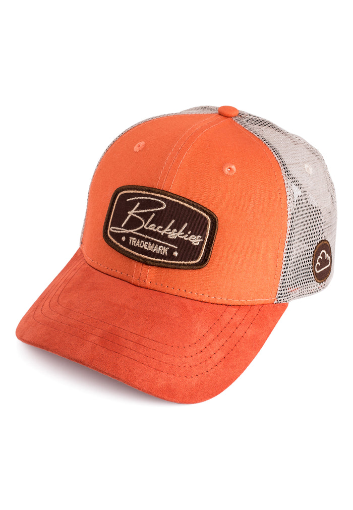 Orange trucker cap with a black and white logo on a white background