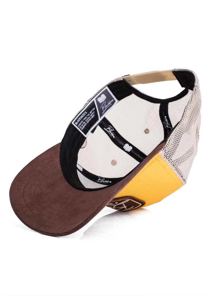 Multicolored cap with brown, yellow, and black design on a white background
