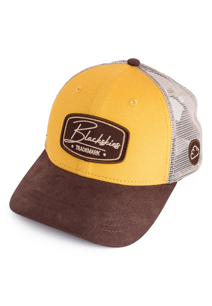 Yellow and brown cap with a Blackies logo on a white background