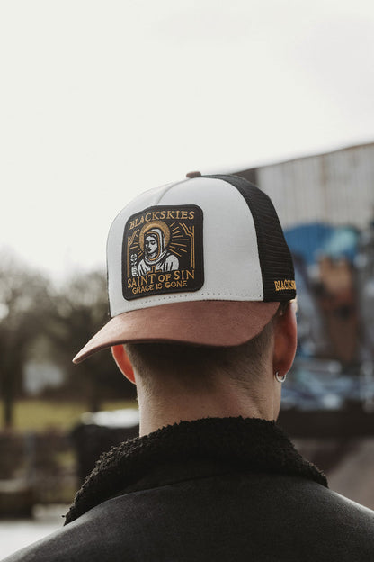 Person wearing a cap with 'Blackskies' branding, facing away from the camera.