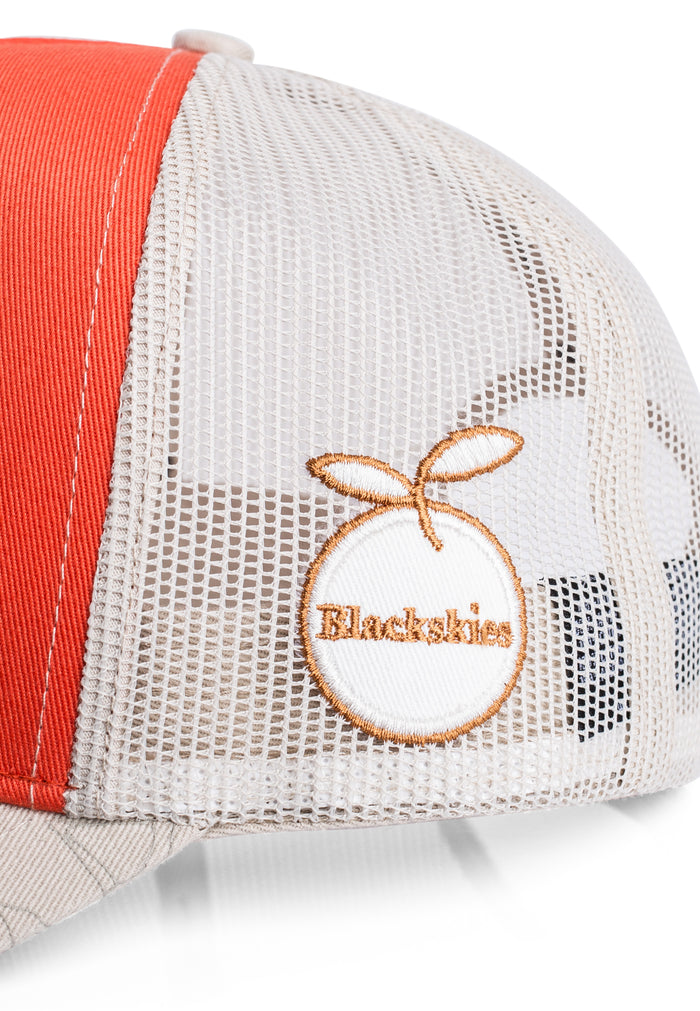 Trucker hat with orange and white design featuring 'Blackskies' brand logo.