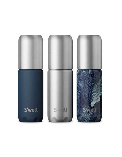 Set of three refillable aluminum travel bottles with leakproof pump, in navy blue, silver, and marbled blue design, with TSA compliant size
