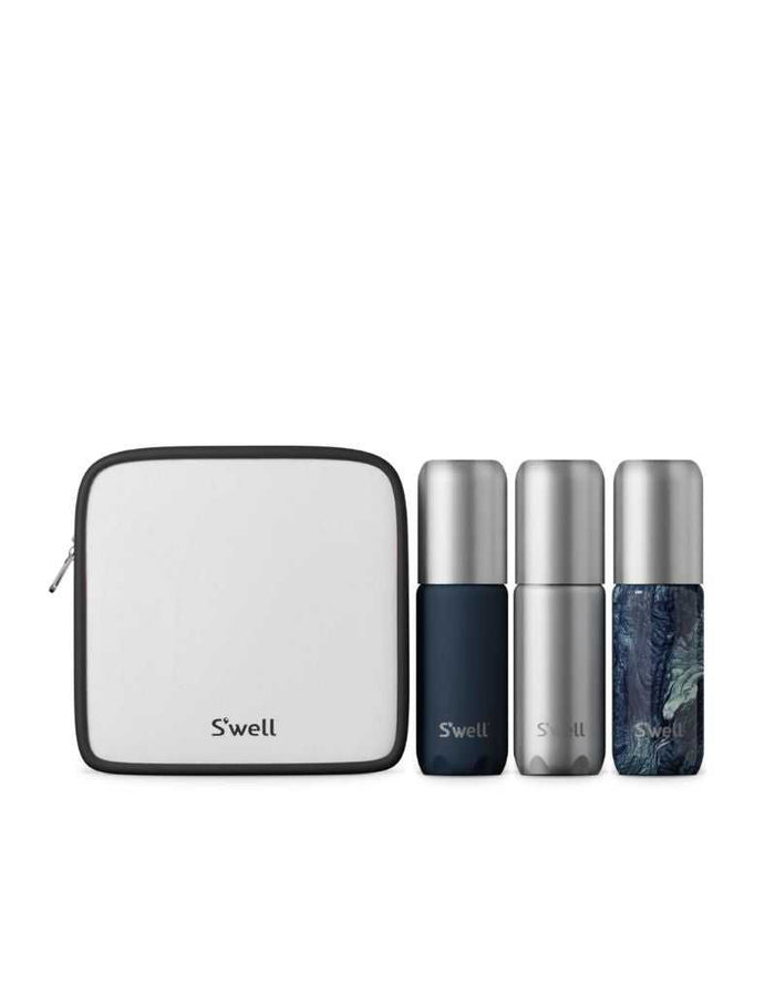 Travel set with three aluminum bottles and a white toiletry bag, featuring navy blue, silver, and marbled blue bottles for personal care