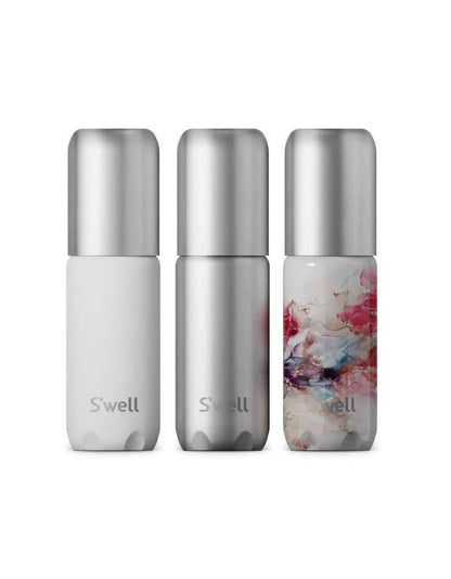 Set of three aluminum travel bottles in white, silver, and pink marbled design with silver caps, for personal care on the go